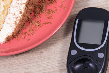 Glucometer for measuring and checking sugar level and sweet cake with chocolate. Nutrition during diabetes