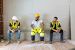© Bogdan Pictures - A cheerful and vibrant group of construction workers taking a welldeserved break on a bustling job site, showcasing their excellent teamwork and unwavering commitment to safety and collaboration