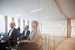 © Johnér - Group of multiracial business colleagues attending seminar seen through glass in office