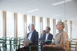 © Johnér - Business colleagues attending seminar seen through glass in office