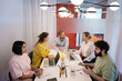 © Johnér - Group of business colleagues discussing over table in office