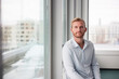 © Johnér - Portrait of young businessman sitting by window in office