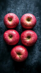 Wall Mural - Fresh pink apples are arranged in a captivating top-down view, glistening with water droplets, showcasing their vibrant color and inviting texture