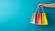 © aiman - Women holding shopping bags, on blue background