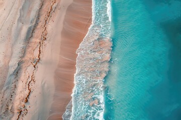 Poster - A beautiful blue ocean with a sandy beach. The water is calm and the waves are small. The beach is empty and the sky is clear