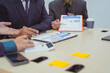© NanSan - Close-up of a businessman in a meeting with a group of businessmen in the office, discussing digital marketing strategies, financial data analysis, and planning business projects together.
