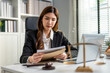 © Kawee - Asian lawyer woman work with hammer and scales of justice in courtroom.