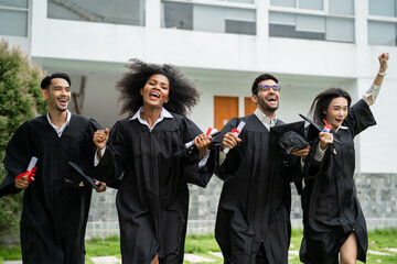 Group of diverse students celebrating college achievement outside campus. 