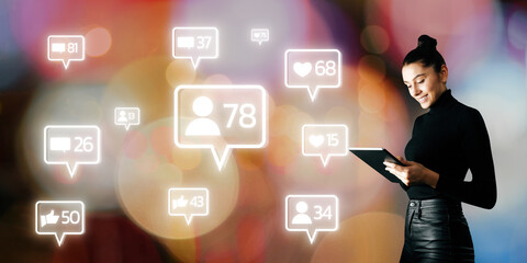 Poster - Attractive happy young european businesswoman using smartphone with creative social media icons on blurry bokeh background. Communication and networking concept.