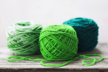 Knitting wool. Green balls of yarn.