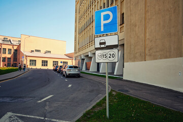 Wall Mural - Parking lot sign on pole in downtown, indicating paid parking zone with specific regulations. Parking zone with paid parking sign in downtown