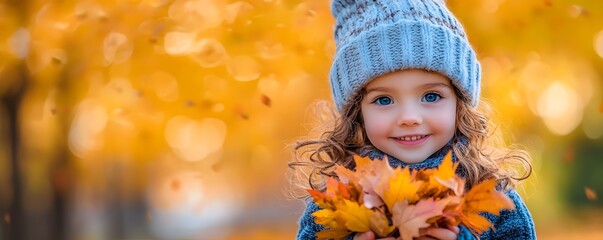 Wall Mural - Adorable Little Girl Holding Autumn Leaves in Forest