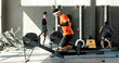 © peopleimages.com - Man, rowing machine and fitness with workout at gym, benefit or training for muscle development. Person, exercise and routine for challenge, start or progress for body transformation at wellness club