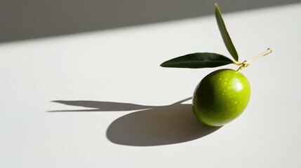 Poster - Single Green Olive with Leaf and Shadow on White Background