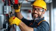 © Pinklife - A bearded electrician smiles while working with cables, wearing an orange safety helmet and gloves, showcasing his skill and focus on safety measures in a professional environment.