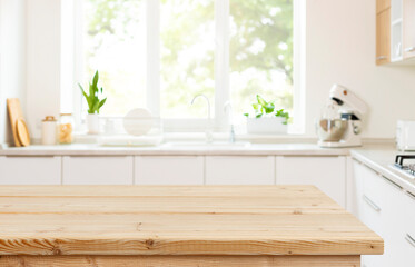 Wall Mural - empty wood table top view for product display montage on blur kitchen counter and wide window backgr