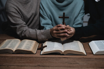 Wall Mural - Closeup of simple wooden Christian cross on Bible. Concept of hope, faith, christianity, religion.