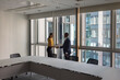 © ReeldealHD images - Business persons handshake in a modern office with views of buildings