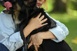 © Prathankarnpap - Loving young woman cuddling her dog showing affection, companionship, trust and care