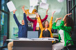 © Phushutter - Asian colleagues, middle-aged man and young woman, happily collaborate in office workplace. They gather around laptop, discussing project management, startup plans, teamwork paper stacks on desk.