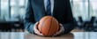 © Anurak - Businessman Holding Basketball.