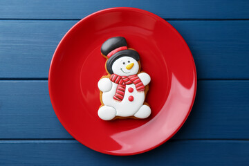 Poster - Delicious cookie in shape of snowman on blue wooden table, top view