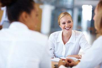 Business people, women and conversation in meeting, smile and brainstorming for ideas. Female professionals, coworkers or group with discussion, cooperation or feedback for opportunity or ideas