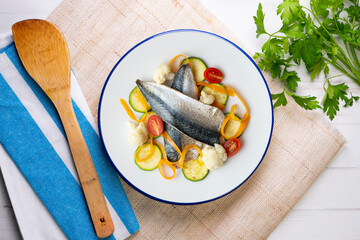 Baked mackerel with delicious and healthy vegetables. Top view table.