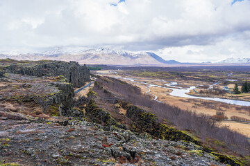 Thingvellir National Park, Iceland: A view of the rift valley where the North American and Eurasian tectonic plates are pulling apart. It offers a unique glimpse into Earth's geological processes.