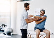 © TamJam/peopleimages.com - Physiotherapist, stretching and mature man in clinic, helping and healthcare with exercise and fitness. Hospital, workout and physiotherapy of patient, rehabilitation and concentration of person