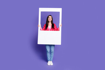 Canvas Print - Full length photo of dreamy positive woman wear pink cardigan rising paper frame looking empty space isolated purple color background