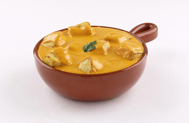 pottery bowl chicken curry tandoori shish with sauce on white background