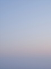 Sticker - A soft, hazy sky at sunrise with muted colors.