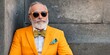 © jambulart - A stylish senior man wearing an orange suit.