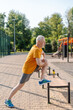 © Maria Vitkovska - Senior man stretching legs using bench after outdoor workout
