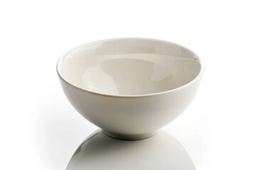 Poster - A simple white bowl placed on a table with a clean background, suitable for use in interior design or product photography