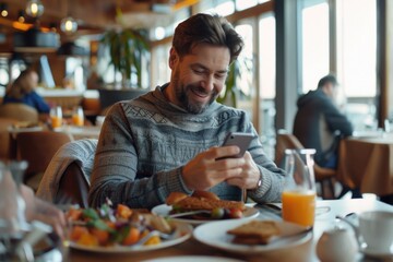 Canvas Print - A person sitting at a table focused on their cell phone, possibly checking messages or emails