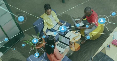 Poster - Animation of network of connections with icons over diverse colleagues using laptop in office