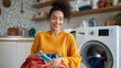 © fotofabrika - A young woman happily sorting fresh laundry in a cozy kitchen on a sunny afternoon