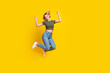 © deagreez - Full size photo of satisfied girl dressed khaki crop top jeans jumping raising arms up win bet isolated on yellow color background
