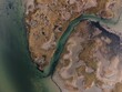 © Wirestock - Aerial view of marshland with water and vegetation