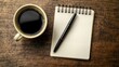© arthit - Office desk with a blank notepad, pen, and a cup of coffee, waiting for a business plan to be written.