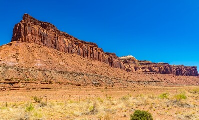 Wall Mural - Stunning view of a red rock formation under clear blue sky in Canyonlands National Park, Utah, USA