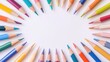 © pinporn manosri - A flat lay of colorful pencils, paints, and brushes arranged in a radial pattern on a white background