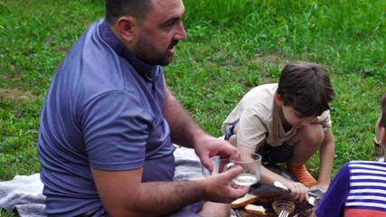 Wall Mural - Father and sons have picnic on the backyard, have fun and time together