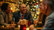 © boba - Christmas gift exchange at work. A group of happy business people are sitting at a table and exchanging gifts. Secret Santa