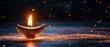 © Sagiam - A beautifully lit Diwali lamp with a background of shimmering bokeh lights enhancing the festive mood