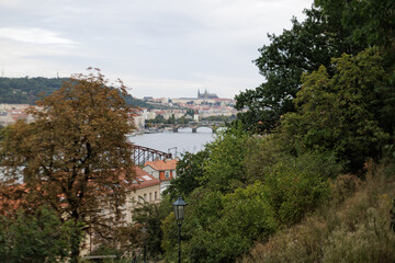 Scenic view of prague castle and bridges from a lush hilltop park vysehrad