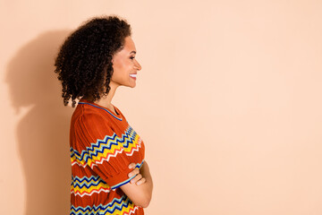 Wall Mural - Side profile photo of cheerful girl dressed ornament t-shirt hands crossed look at logo empty space isolated on pastel color background