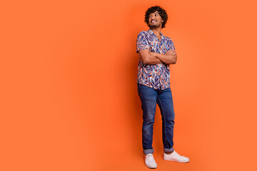 Sticker - Full size photo of nice young man look empty space folded hands wear trendy colorful outfit isolated on orange color background